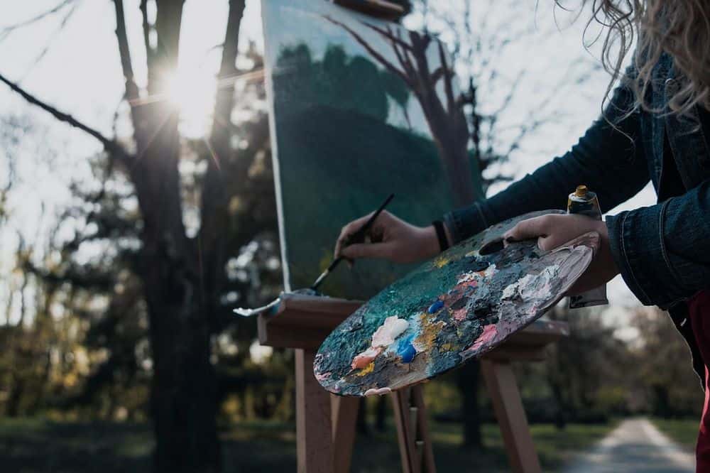 woman painting outdoors after microdosing weed